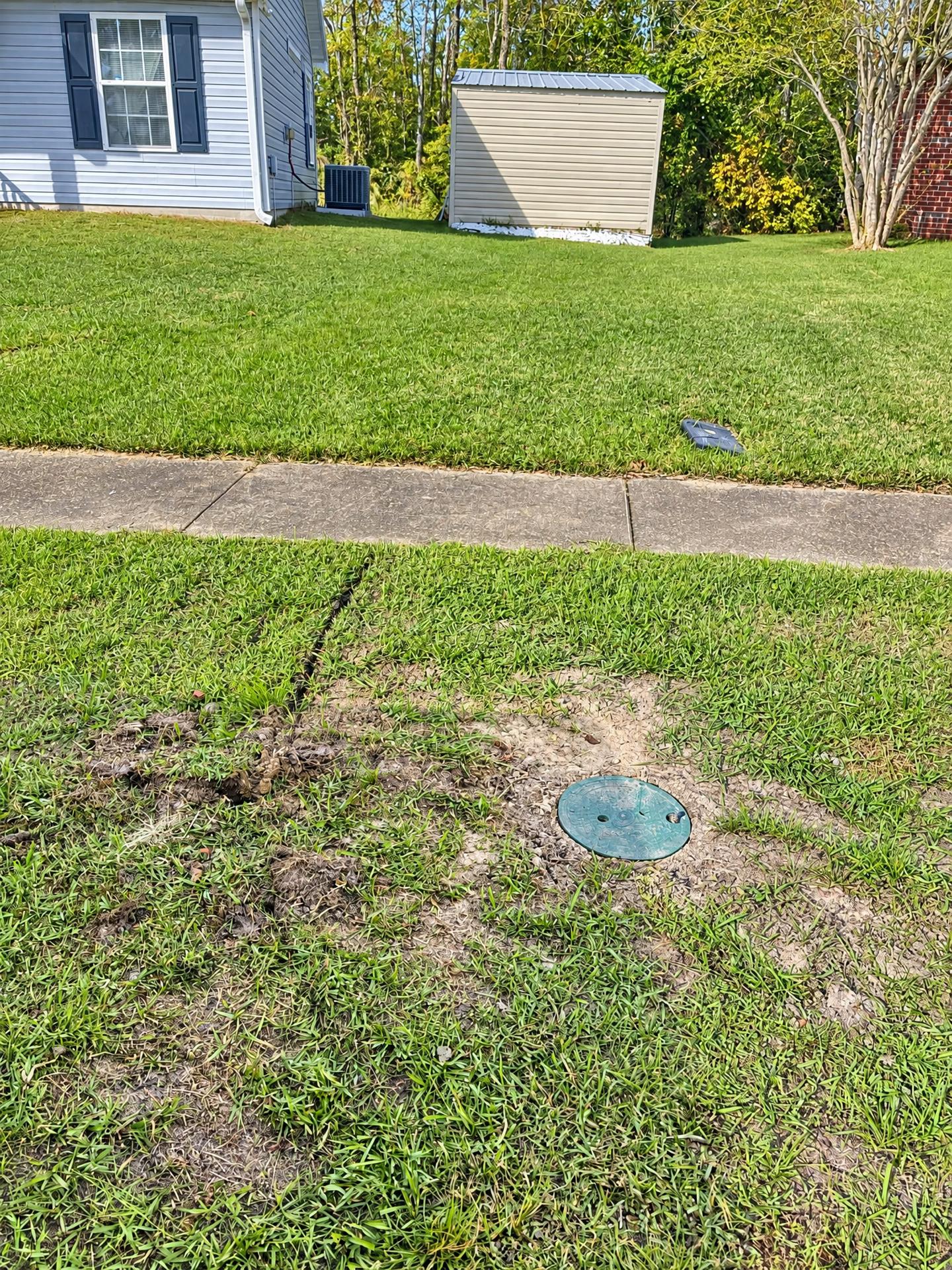 Lawn after a fiber install with the new handhole in place